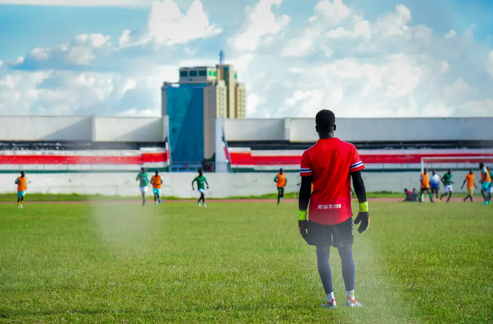 A goalkeeper watching the game from his goal